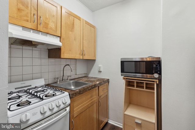 kitchen featuring white range with gas cooktop, sink, and decorative backsplash