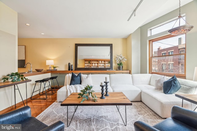 living room featuring recessed lighting, rail lighting, and wood finished floors