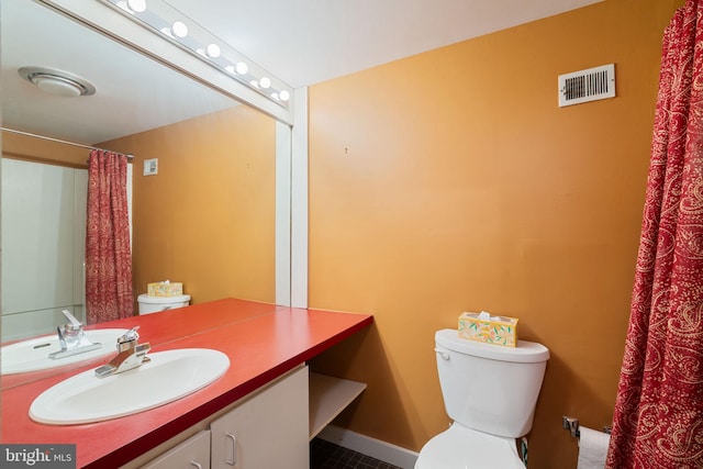 full bathroom featuring visible vents, toilet, and vanity