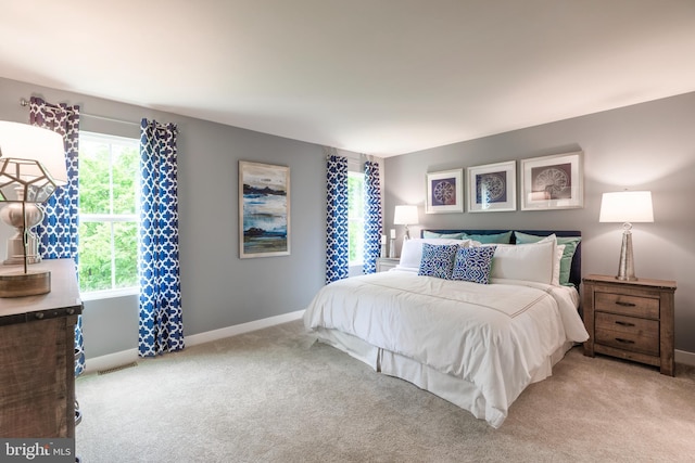 bedroom featuring light colored carpet