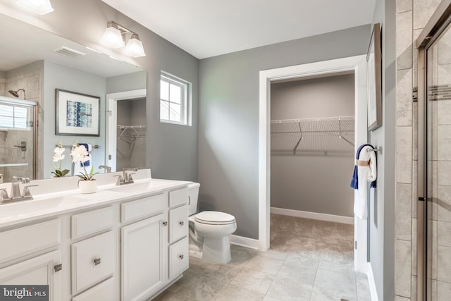 bathroom featuring walk in shower, vanity, and toilet