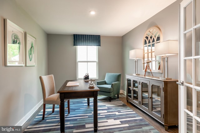 home office with dark hardwood / wood-style floors