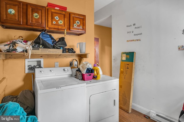 clothes washing area featuring separate washer and dryer and light wood-type flooring