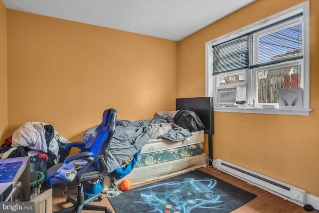 bedroom featuring a baseboard radiator and wood-type flooring