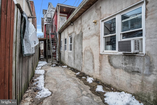 snow covered property featuring cooling unit