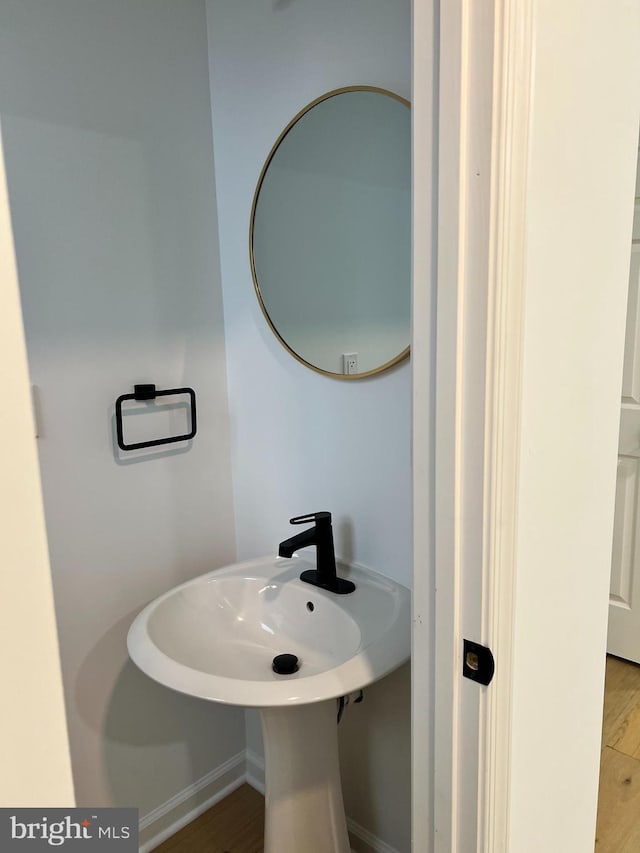 bathroom with wood-type flooring