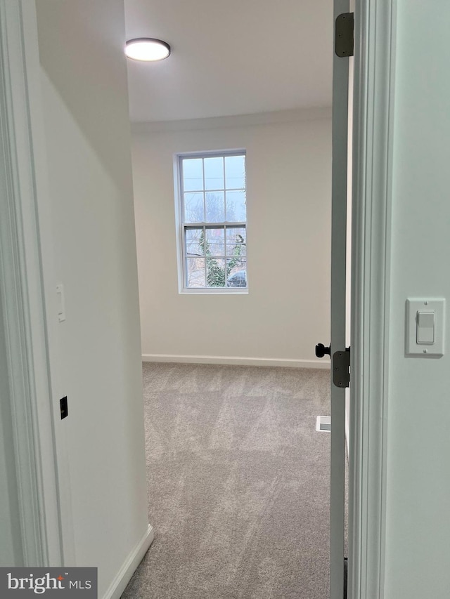 unfurnished room featuring light colored carpet