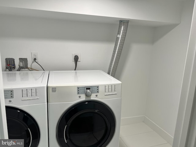 washroom featuring washing machine and dryer and tile patterned floors