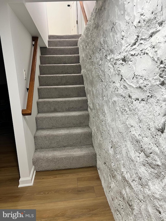 staircase featuring hardwood / wood-style floors