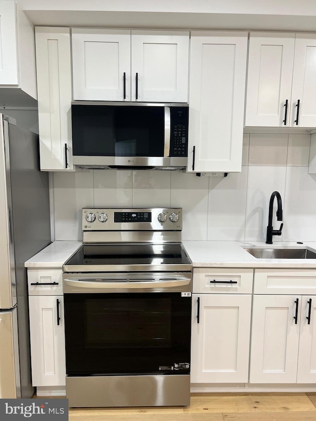 kitchen featuring white cabinetry, appliances with stainless steel finishes, and sink