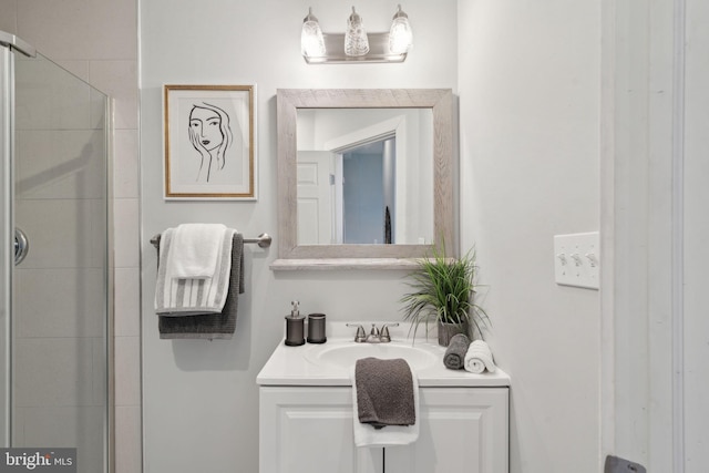 bathroom featuring vanity and an enclosed shower