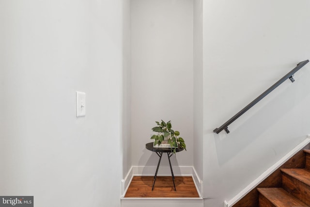 stairs featuring hardwood / wood-style flooring