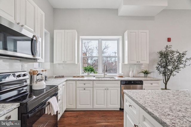 kitchen with white cabinetry, sink, and stainless steel appliances
