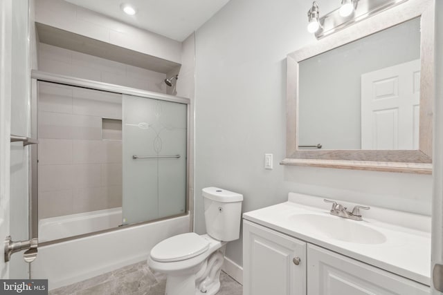 full bathroom featuring bath / shower combo with glass door, vanity, and toilet