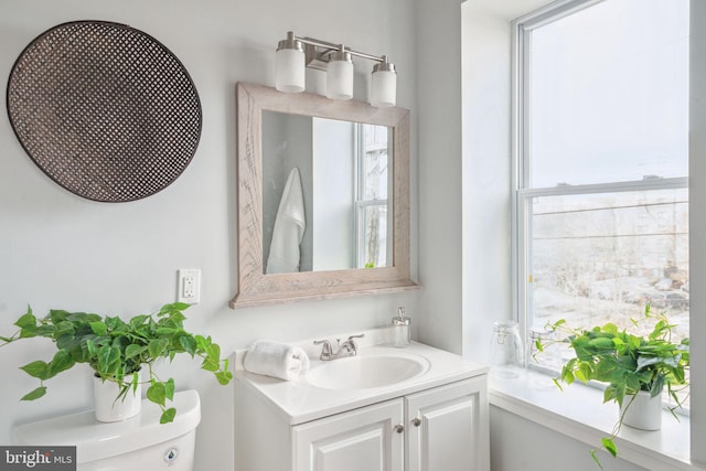 bathroom featuring vanity and toilet