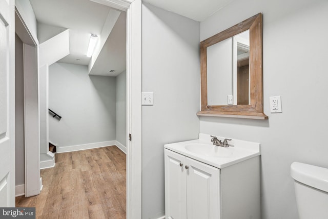 bathroom featuring vanity, toilet, and wood-type flooring