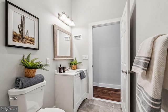 bathroom featuring vanity and toilet
