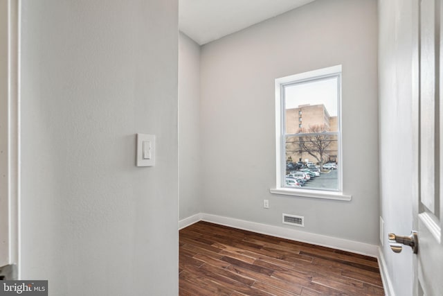 spare room with dark hardwood / wood-style flooring
