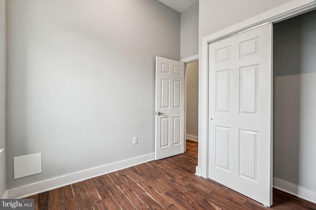 unfurnished bedroom with dark wood-type flooring