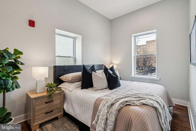 bedroom with dark hardwood / wood-style floors