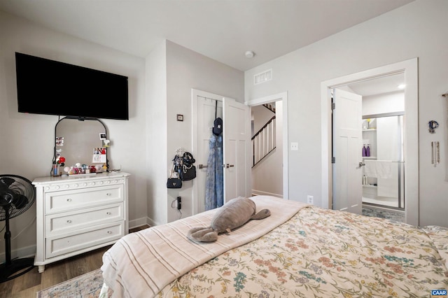 bedroom with dark hardwood / wood-style floors