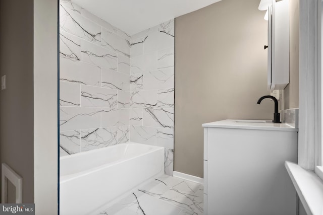 bathroom featuring marble finish floor, baseboards, vanity, and shower / tub combination