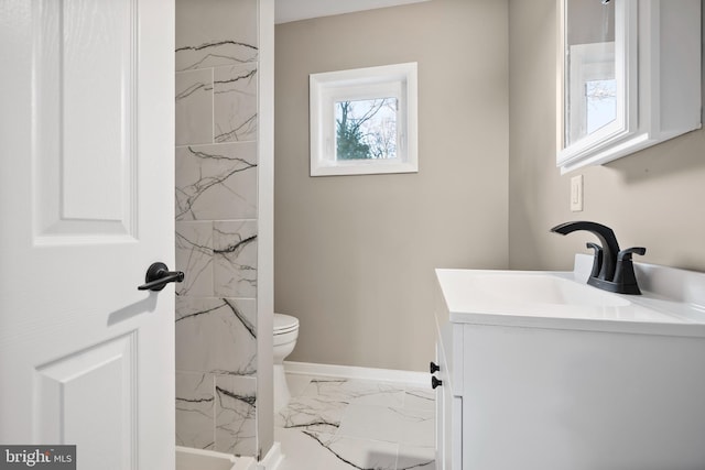 full bath with toilet, marble finish floor, baseboards, and vanity