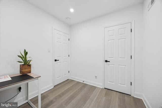 interior space with recessed lighting, light wood-type flooring, visible vents, and baseboards