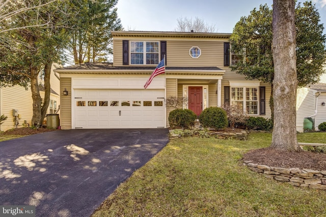 view of property featuring a front yard and a garage