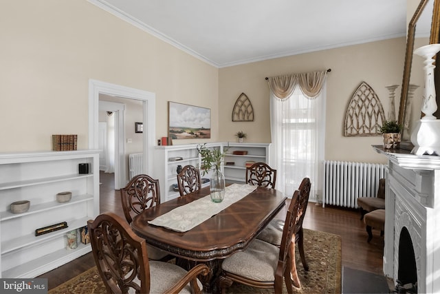 dining space with a fireplace with flush hearth, dark wood finished floors, and radiator heating unit