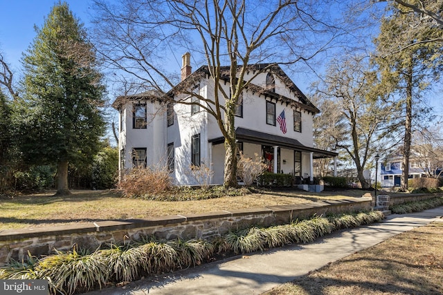 view of property exterior featuring a chimney and stucco siding