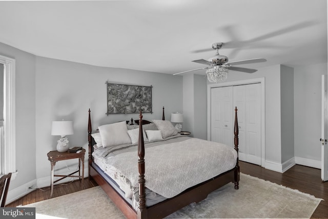 bedroom featuring ceiling fan, a closet, wood finished floors, and baseboards