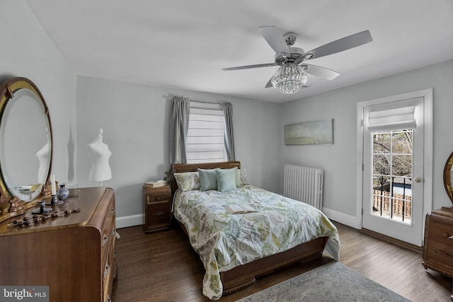 bedroom featuring radiator, access to outside, baseboards, and wood finished floors