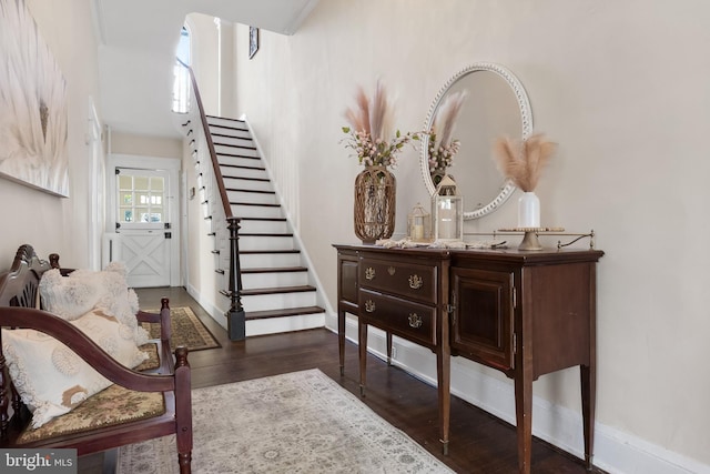 entryway featuring dark wood-style floors, stairway, and baseboards