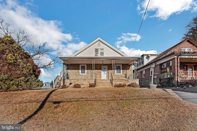 view of front of house with a front lawn and a porch