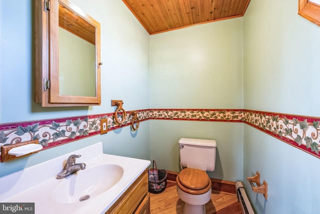 bathroom with hardwood / wood-style floors, vanity, a baseboard heating unit, wood ceiling, and toilet