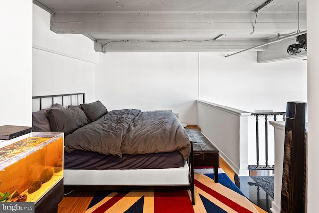 bedroom with dark hardwood / wood-style flooring