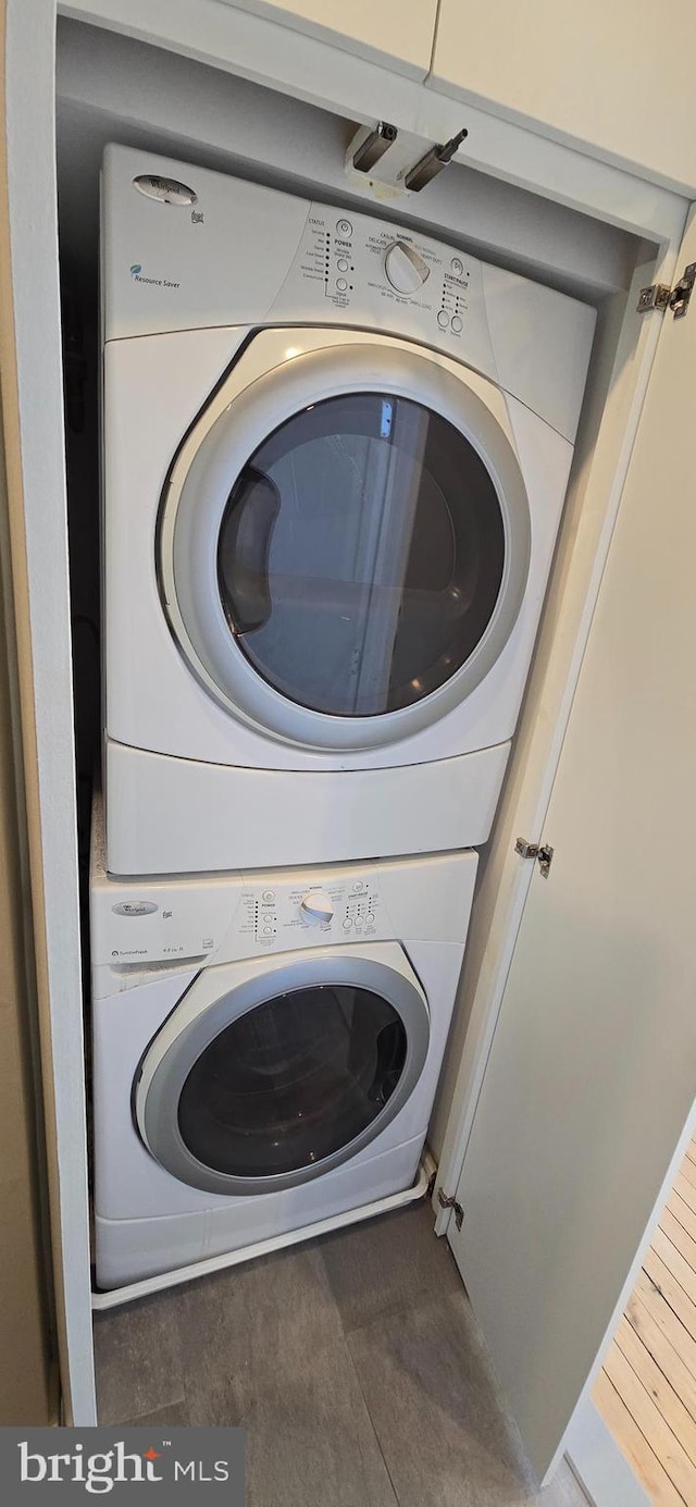 laundry area featuring stacked washer / drying machine