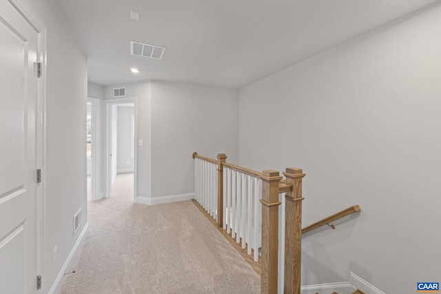 hallway featuring light carpet