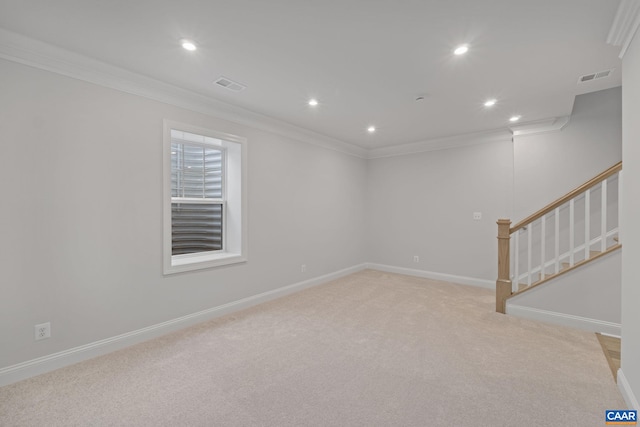 unfurnished room featuring crown molding and light colored carpet