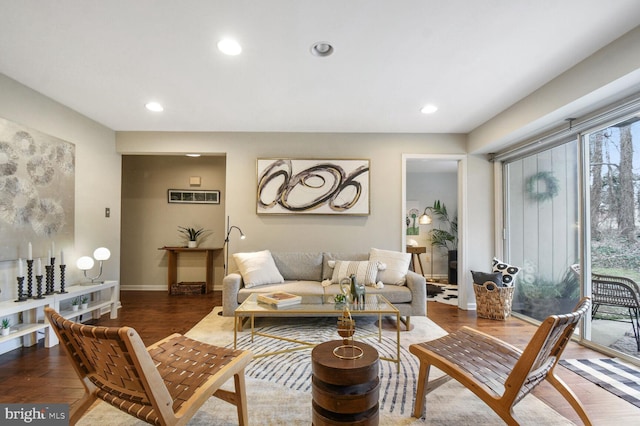 living room featuring baseboards, wood finished floors, and recessed lighting