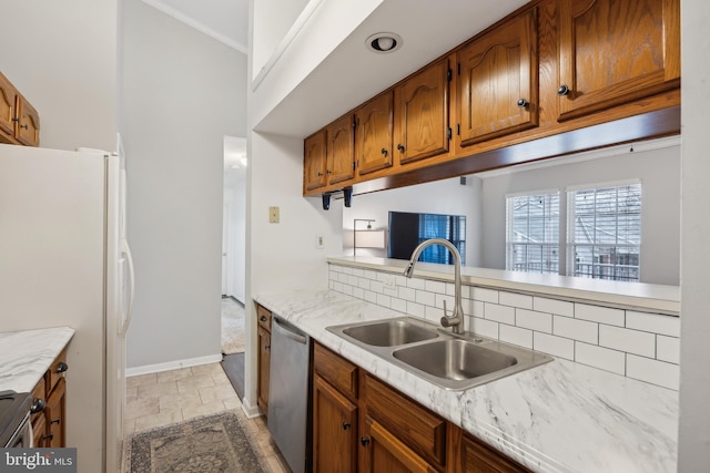 kitchen with dishwasher, sink, and white fridge