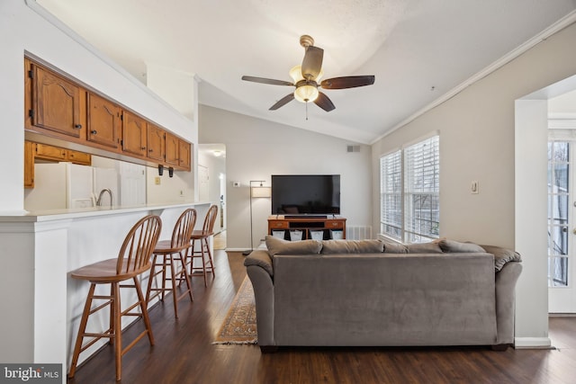 living room with ceiling fan, lofted ceiling, crown molding, and dark hardwood / wood-style flooring