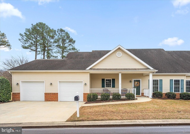 view of front of property with a porch, a garage, and a front lawn