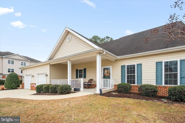 view of front facade with a porch, a garage, and a front yard