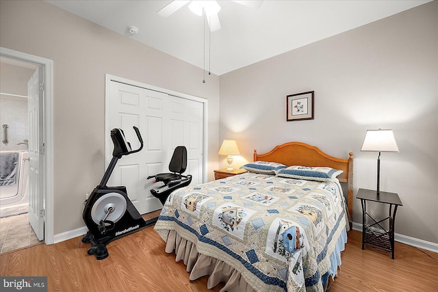 bedroom with wood-type flooring, ensuite bath, ceiling fan, and a closet