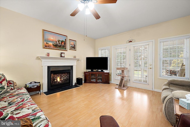 living room featuring hardwood / wood-style floors and ceiling fan