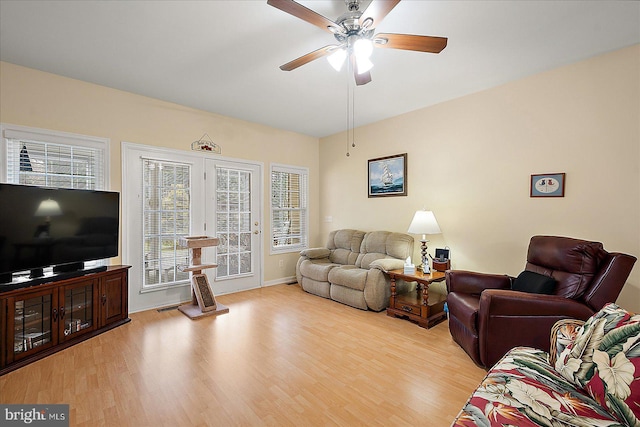 living room with ceiling fan and light wood-type flooring