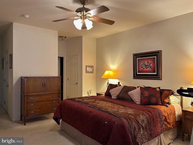 bedroom featuring light carpet and ceiling fan