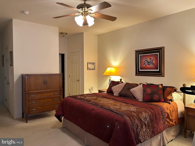 bedroom featuring a ceiling fan and light carpet